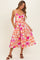 woman wearing a floral midi dress with pink and orange flowers and a fitted bodice with straps
