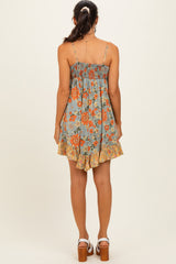 woman wearing a blue floral sundress with a smocked bodice and ruffled hem, seen from the back