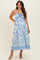 woman wearing a white maternity dress with blue abstract patterns and adjustable spaghetti straps