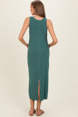 woman wearing a teal sleeveless maternity maxi dress with a thigh-high slit at the back