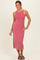 woman wearing a pink ribbed tank dress with a midi length and sandals, standing and smiling
