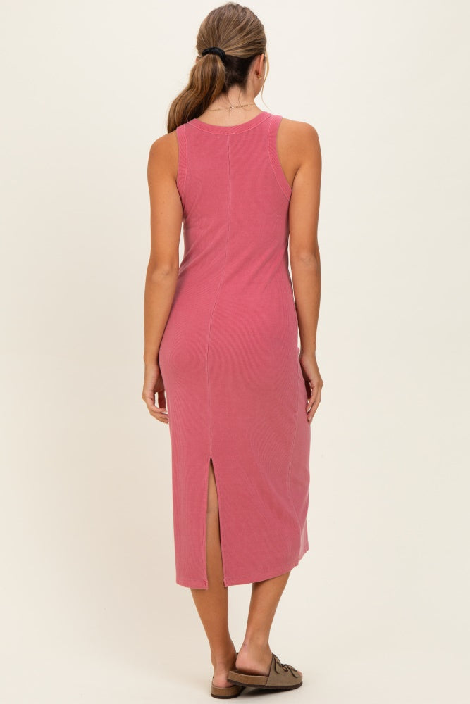 woman wearing a rose pink sleeveless midi dress with a back slit detail