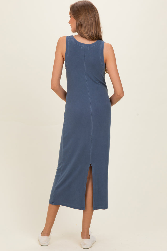 woman wearing a blue sleeveless maternity dress with a back slit, showing off a comfortable fit