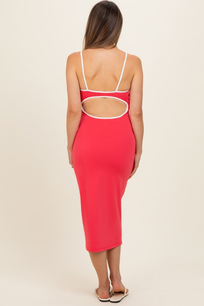 woman wearing a red maternity dress with an open back and white trim detailing