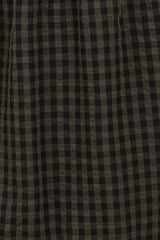 black and olive checkered patterned fabric draped softly