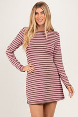 woman wearing a pink and mauve striped long sleeve mini dress with a relaxed fit