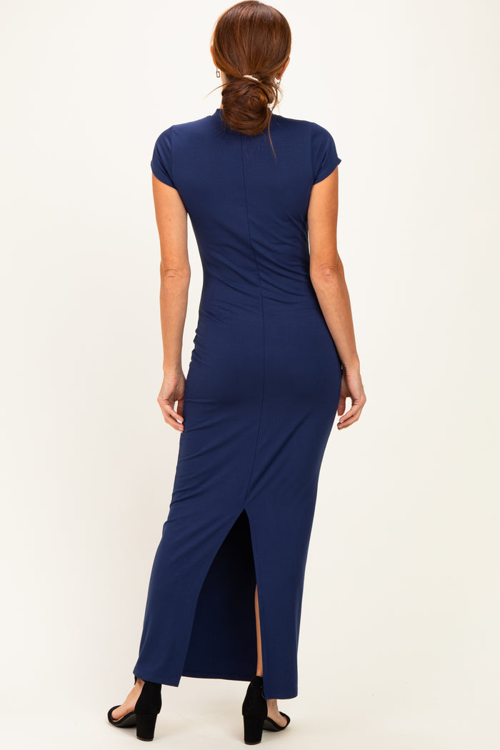 woman wearing a navy blue fitted maxi dress with a back slit and cap sleeves