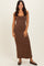 woman wearing a fitted brown maxi dress with a scoop neckline and a straight silhouette