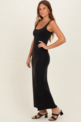 woman wearing a black sleeveless maxi dress with a fitted silhouette and sandals