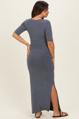 woman wearing a gray ribbed maternity maxi dress with short sleeves and side slits, showing her baby bump