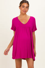 woman wearing a fuchsia short sleeve maternity dress with a v-neck and gathered empire waist, showing baby bump