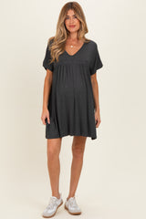 woman wearing a dark gray short sleeve maternity dress with a v-neck and baby bump visible