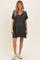 woman wearing a dark gray short sleeve maternity dress with a v-neck and baby bump visible