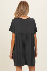 woman wearing a dark gray maternity dress with a flowy back and short sleeves
