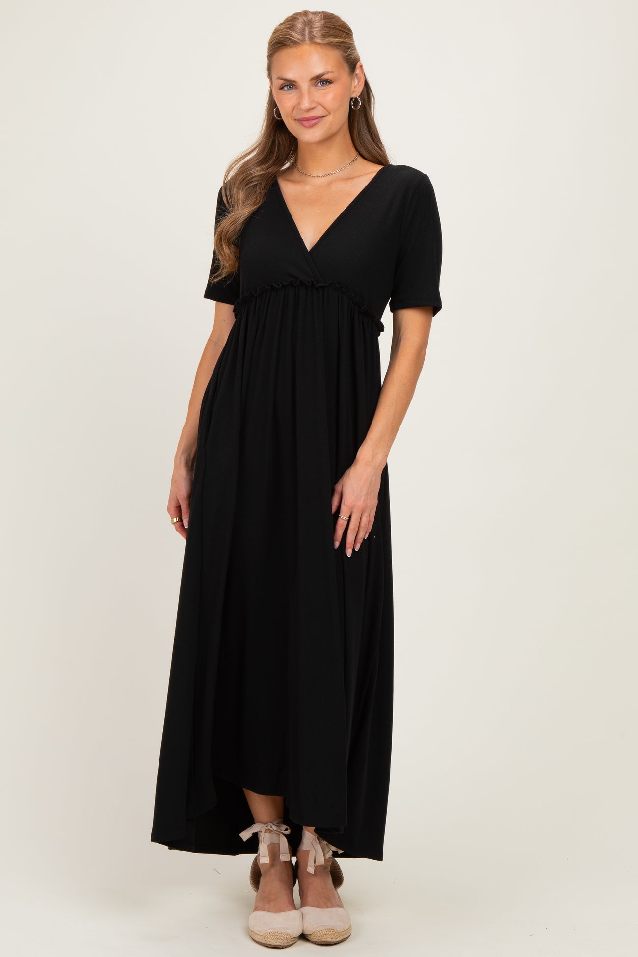 woman wearing a black short sleeve maxi dress with a v-neck and gathered waistline