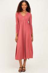 woman wearing a rust ribbed maxi dress with long sleeves and a button-down neckline