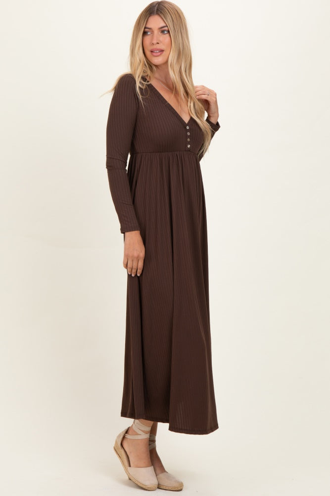 woman wearing a chocolate brown long sleeve maxi dress with a v-neckline and button details