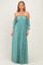 woman wearing a teal off-the-shoulder maxi dress with long puff sleeves and a flowing skirt