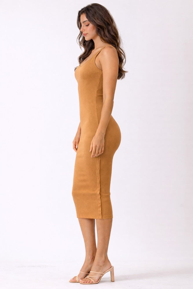woman wearing a mustard ribbed midi dress with a fitted silhouette and sleeveless design