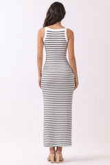 woman wearing a fitted white and navy striped maxi dress, view from the back