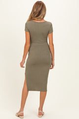 woman wearing a green ribbed short sleeve maternity midi dress with side slits