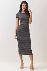 woman wearing a black and white striped midi dress with short sleeves and a fitted silhouette