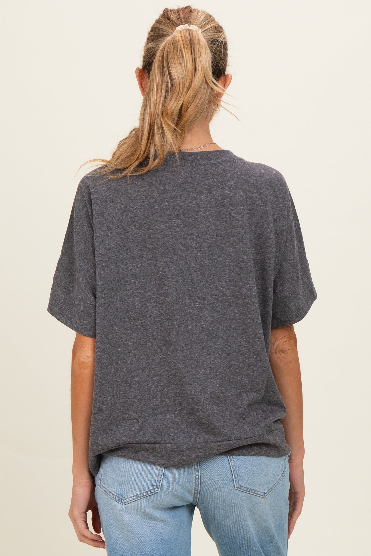 woman wearing a gray short sleeve maternity t-shirt with a relaxed fit, view from the back