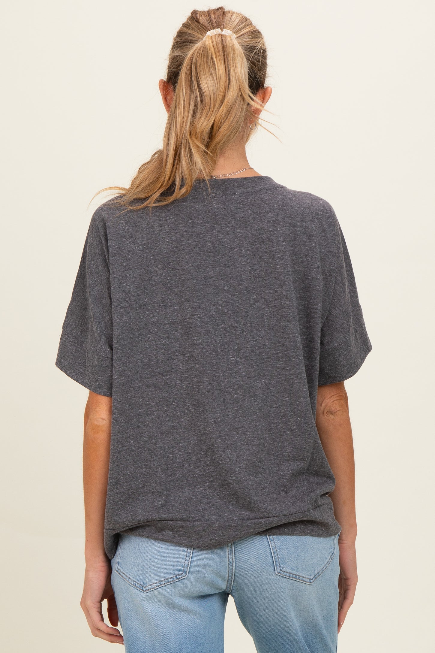 woman wearing a gray short sleeve maternity t-shirt with a relaxed fit, view from the back