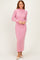 woman wearing a pink long sleeve ribbed maxi dress with a high neck and fitted silhouette