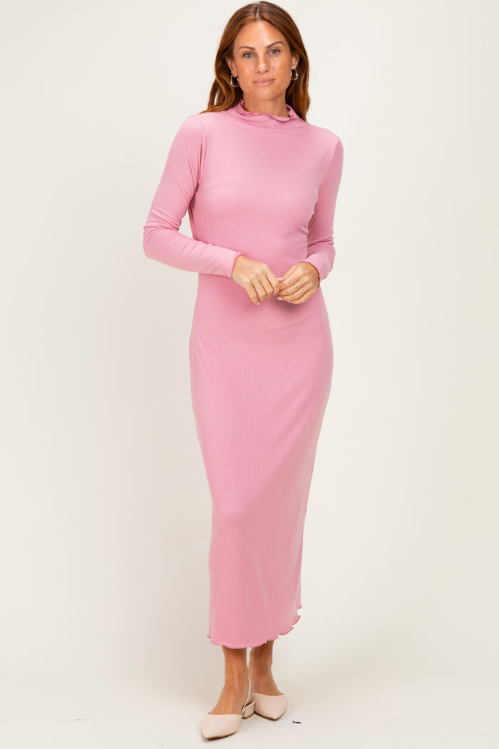 woman wearing a pink long sleeve ribbed maxi dress with a high neck and fitted silhouette