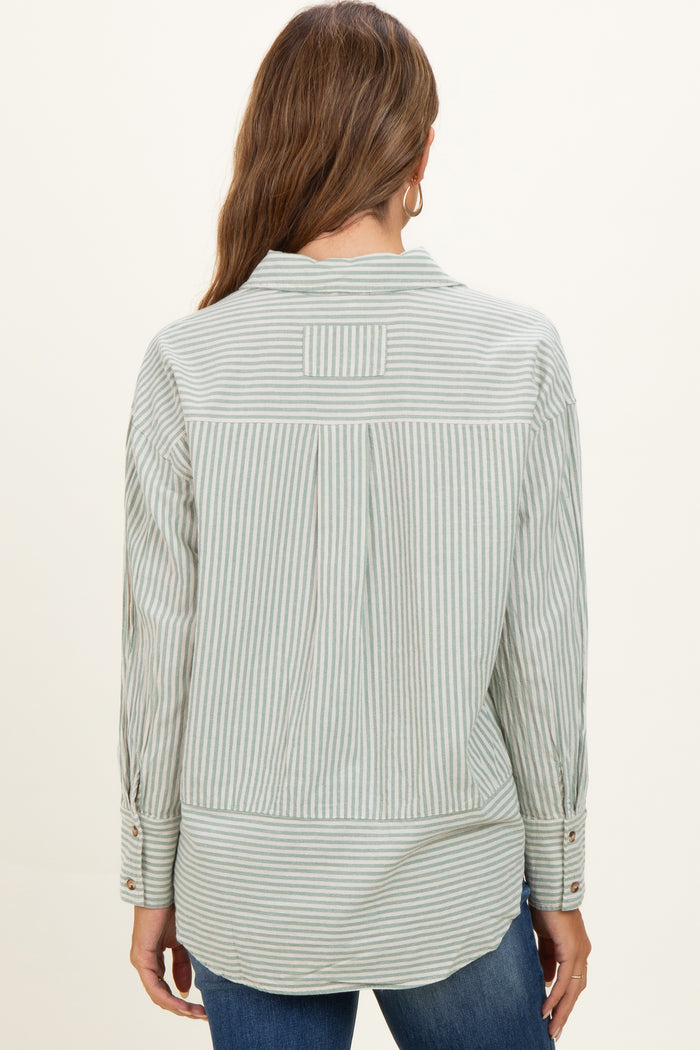 woman wearing a green and white striped maternity button-up shirt, shown from the back