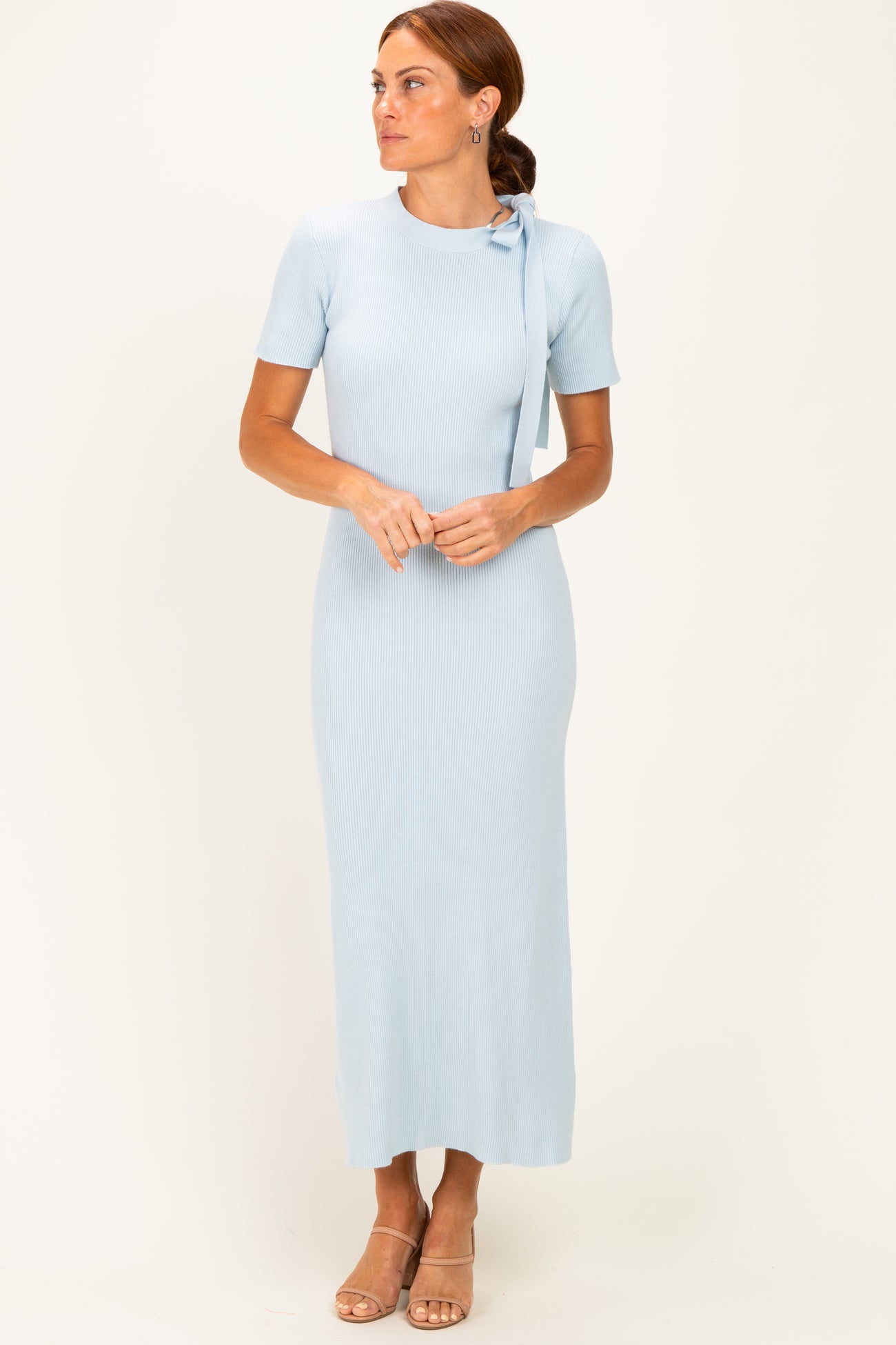 woman wearing a light blue ribbed maxi dress with short sleeves and a tie detail at the shoulder