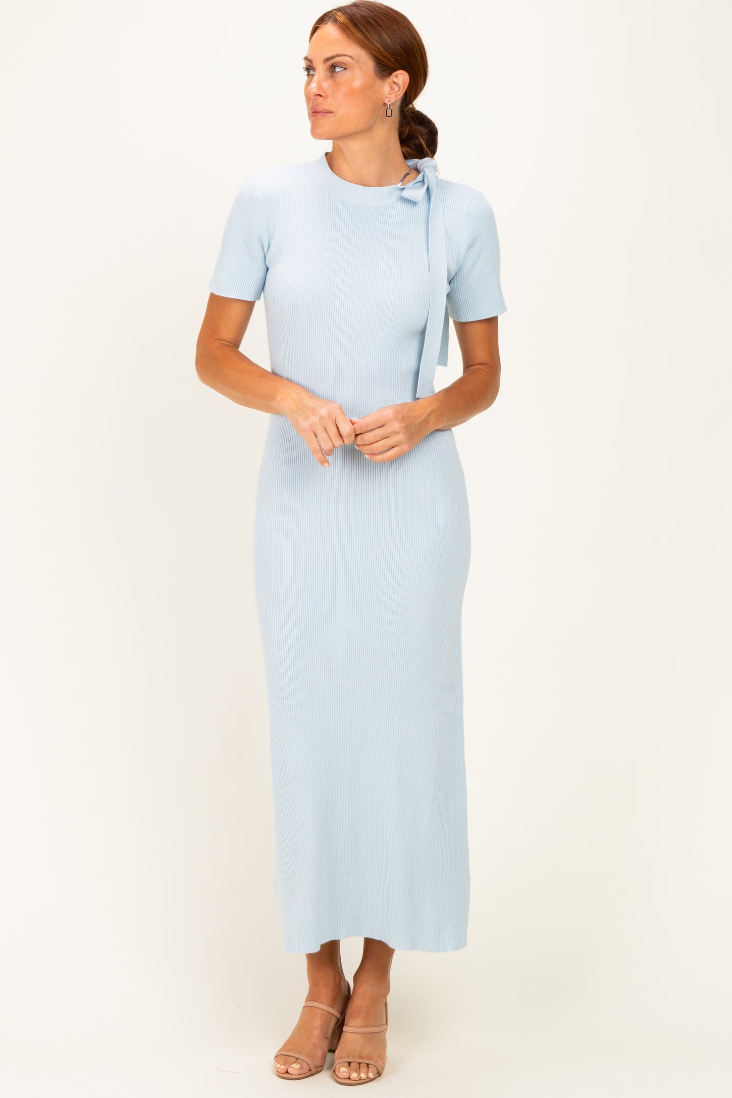 woman wearing a light blue ribbed maxi dress with short sleeves and a tie detail at the shoulder
