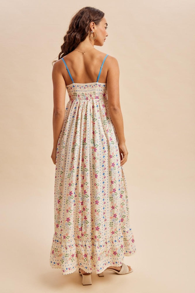 woman wearing a floral print maxi dress with spaghetti straps and a smocked back