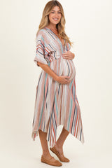 woman wearing a striped maternity dress with an asymmetrical hem and holding her baby bump