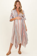 woman wearing a striped maternity maxi dress with a deep v-neck and holding her baby bump