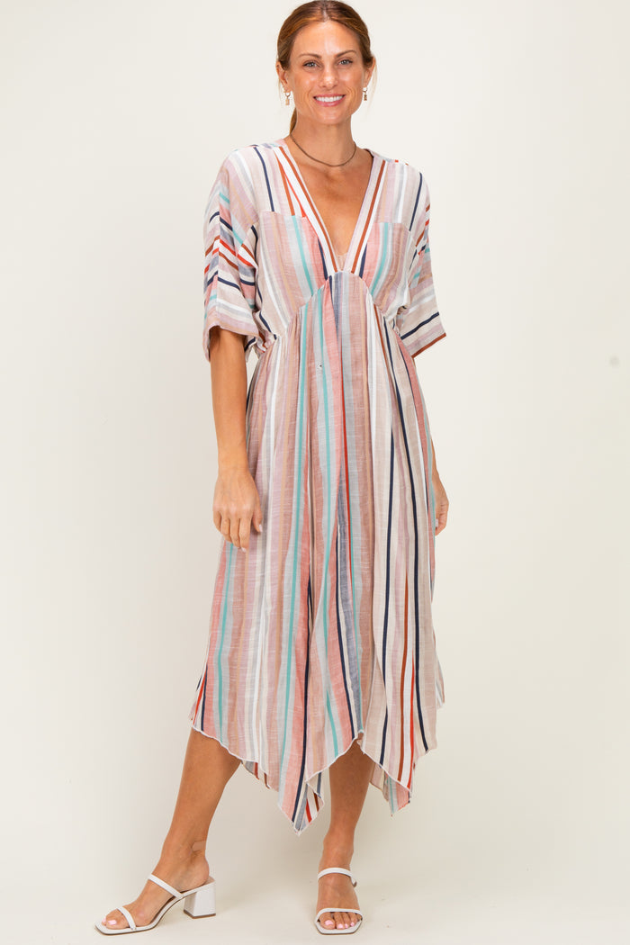 woman wearing a multi-striped maxi dress with a deep v-neck and short sleeves, standing and smiling