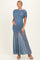 woman wearing a blue maternity dress with ruched bodice and flowy sheer skirt, holding her baby bump