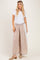 woman wearing a white short sleeve top and beige striped wide-leg pants with elastic waistband