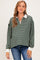 woman wearing a green and white striped long sleeve maternity top with a collar and a relaxed fit