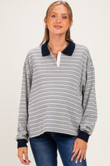 woman wearing a striped maternity pullover with a navy collar and a visible baby bump