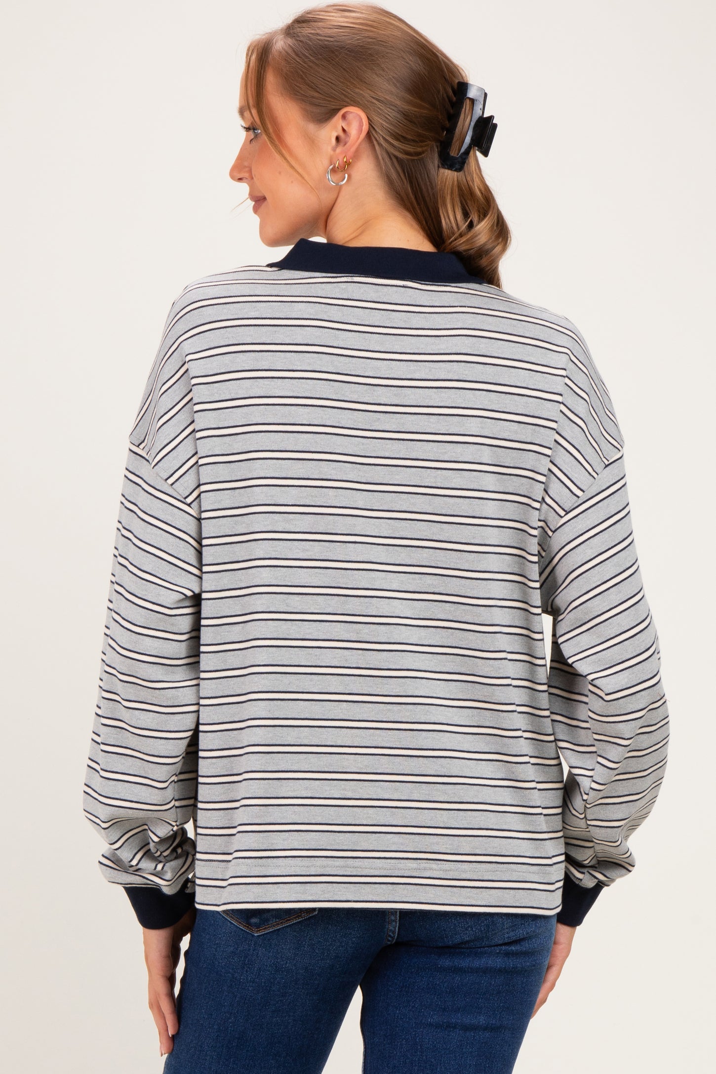 woman wearing a gray striped maternity sweatshirt with a relaxed fit and cuffed sleeves, showing the back view