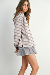woman wearing a pink and white striped long sleeve top with a ruffled checkered mini skirt
