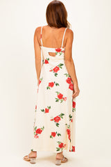 woman wearing a floral maxi dress with a keyhole back detail, shown from the back with red roses on a light background