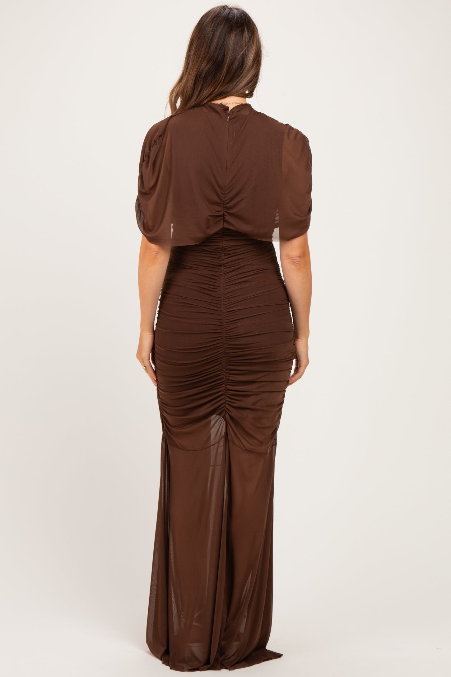 woman wearing a brown ruched maternity dress with a fitted silhouette and short sleeves, showing her baby bump from the back