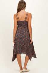 woman wearing a dark floral maternity dress with adjustable straps and a high-low hemline