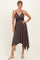 woman wearing a navy blue floral print sundress with a high-low hem and lace detailing, posing confidently