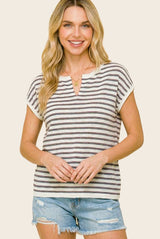 woman wearing a striped short sleeve top with a v-neckline and distressed denim shorts