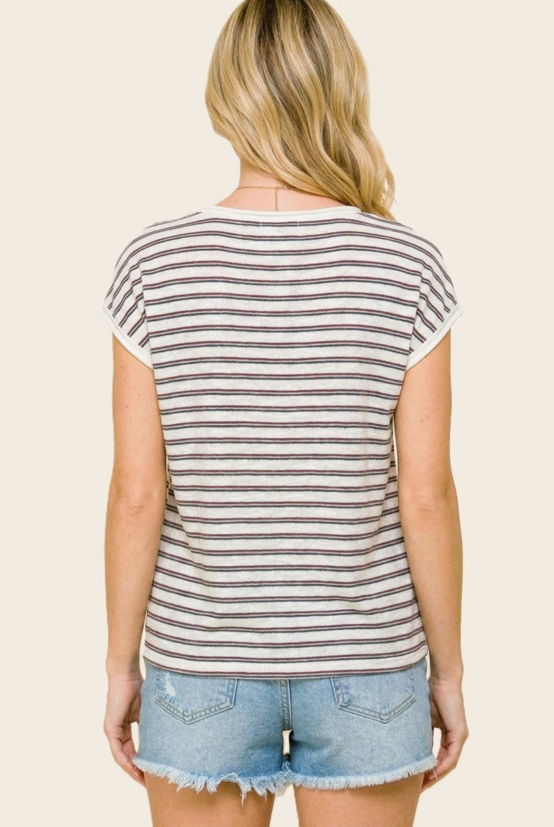 woman wearing a striped short sleeve top with a rounded hem and light blue denim shorts