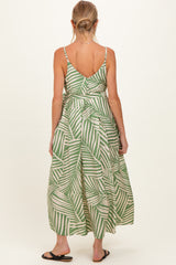 woman wearing a green and white striped maternity maxi dress with a back tie detail and adjustable straps
